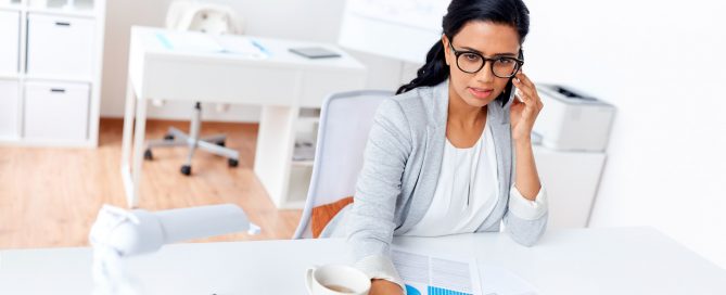businesswoman calling on smartphone at office