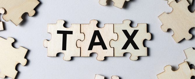 Puzzle pieces with word tax